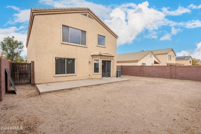 rear view of house featuring cooling unit and a patio