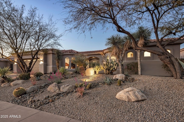 mediterranean / spanish-style home with stucco siding and a tile roof