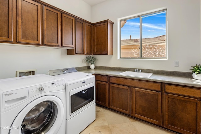 laundry room with cabinet space, washer and dryer, light tile patterned flooring, and a sink