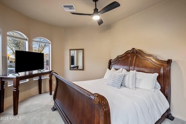 bedroom featuring a ceiling fan, light colored carpet, and visible vents