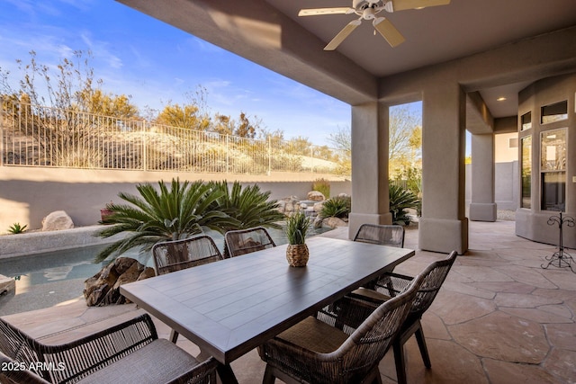 view of patio featuring outdoor dining space, a fenced backyard, and ceiling fan