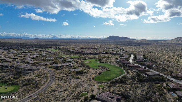 bird's eye view with view of golf course and a mountain view