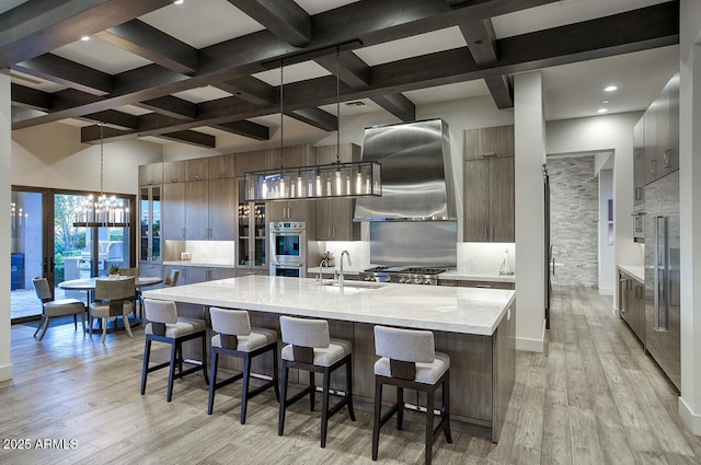 kitchen featuring appliances with stainless steel finishes, modern cabinets, backsplash, and a chandelier