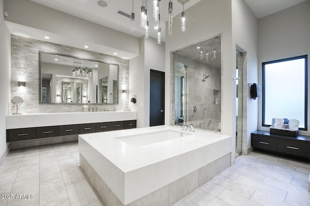 bathroom featuring a bath, visible vents, a shower stall, vanity, and tile patterned floors