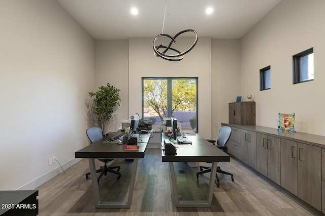 office area featuring light wood-style floors and baseboards