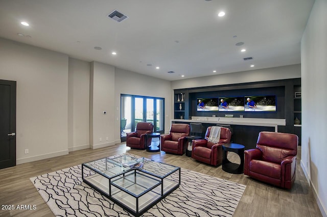 living room with baseboards, recessed lighting, wood finished floors, and visible vents