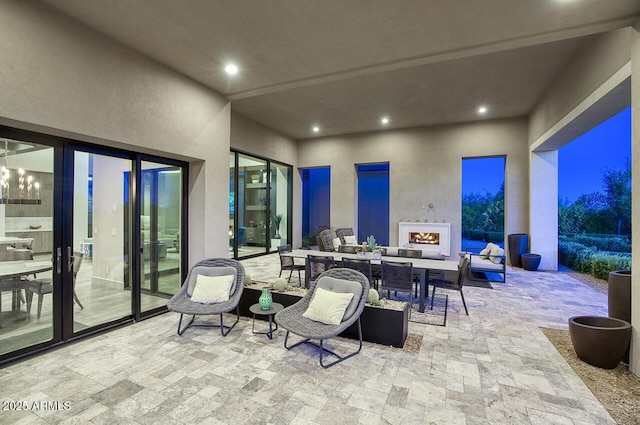 view of patio featuring an outdoor living space with a fireplace