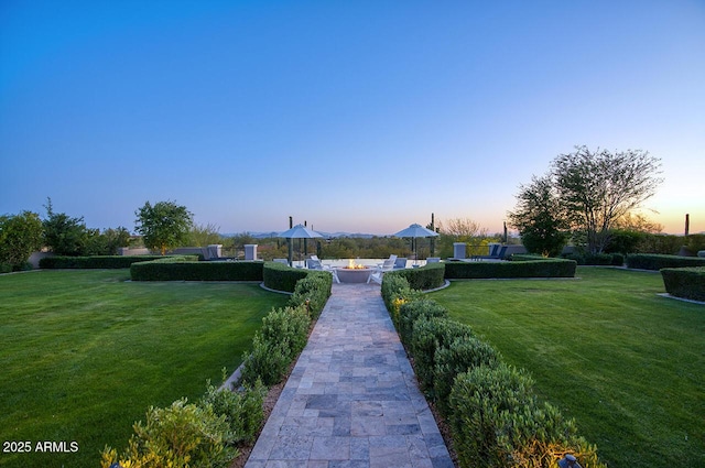 view of property's community with a patio and a yard