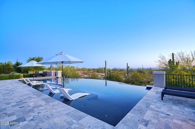 view of swimming pool featuring a patio area
