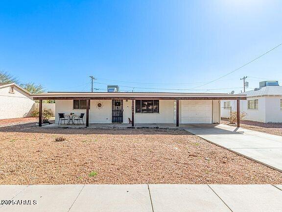 ranch-style house featuring a garage and covered porch