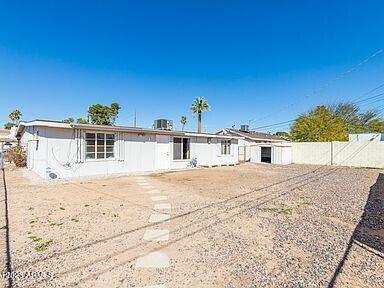 rear view of property with a fenced backyard