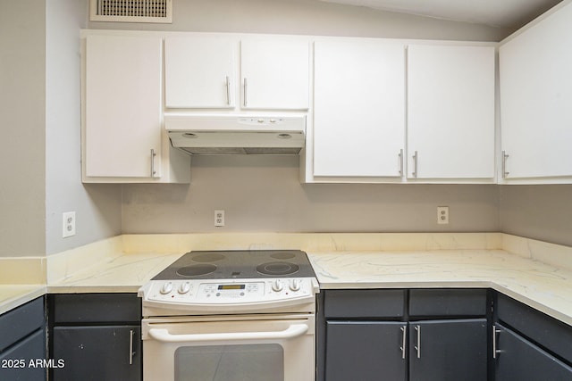 kitchen with visible vents, white electric stove, under cabinet range hood, and white cabinetry