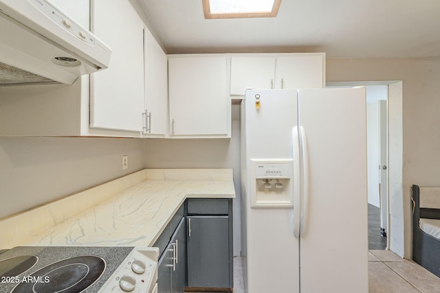 kitchen featuring white fridge with ice dispenser, white cabinetry, range, and under cabinet range hood