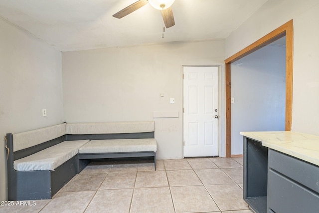 bathroom with a ceiling fan and tile patterned floors