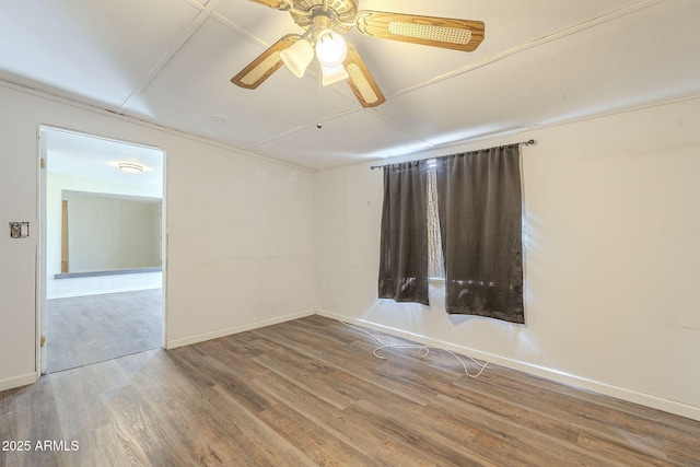 unfurnished room with ceiling fan, baseboards, and wood finished floors