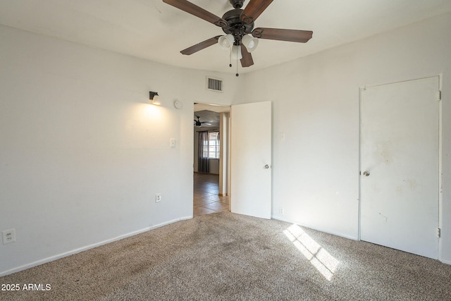 unfurnished bedroom with carpet, visible vents, and ceiling fan