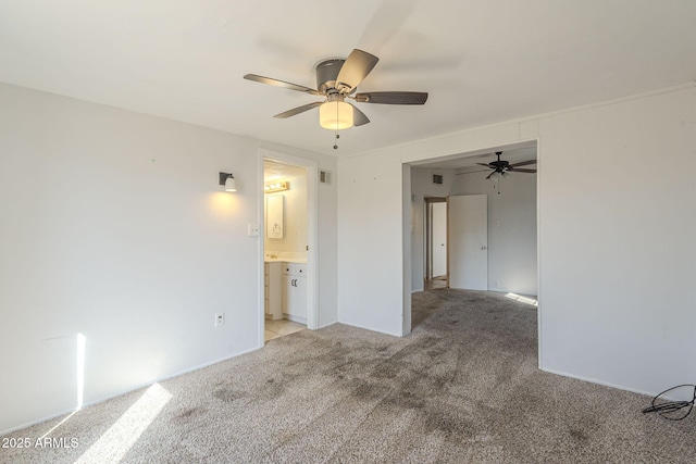 spare room featuring ceiling fan, visible vents, and light colored carpet