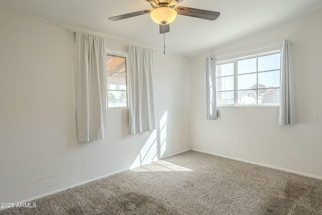 carpeted empty room with baseboards, a ceiling fan, and ornamental molding