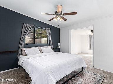 bedroom featuring ceiling fan, carpet floors, and vaulted ceiling