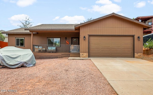 ranch-style home with a garage and a porch