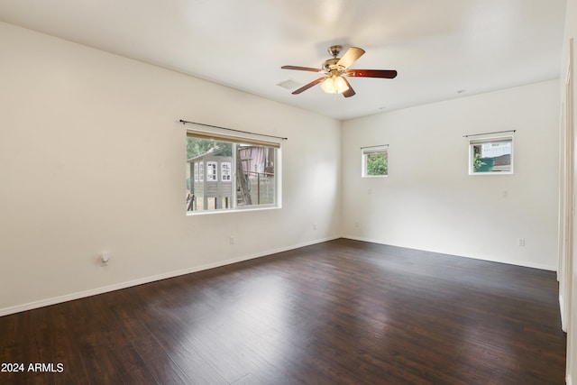 empty room featuring ceiling fan, plenty of natural light, and hardwood / wood-style flooring