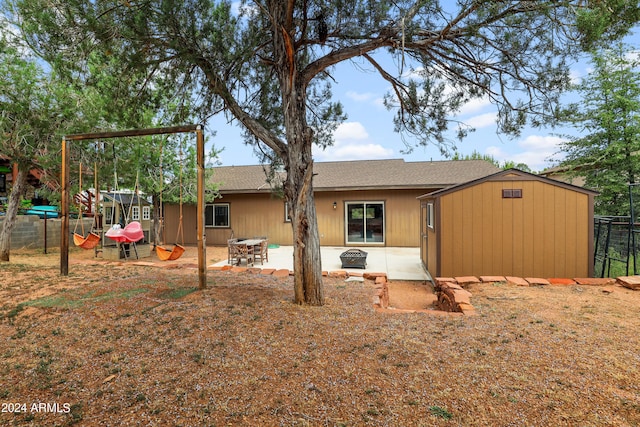 back of house with a patio area and a fire pit