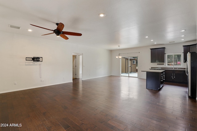 unfurnished living room with sink, dark wood-type flooring, and ceiling fan