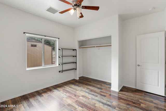 unfurnished bedroom with ceiling fan, wood-type flooring, and a closet