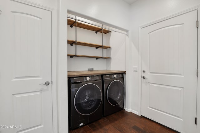 washroom with washer and dryer and dark wood-type flooring