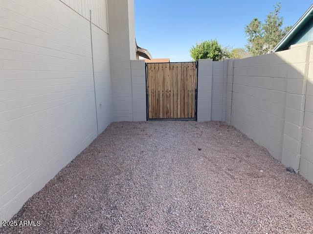 exterior space featuring a gate and fence