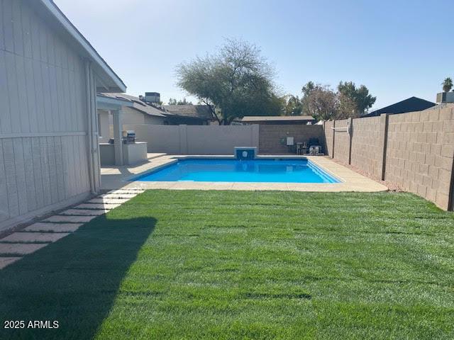 view of pool with a fenced in pool, a fenced backyard, and a yard