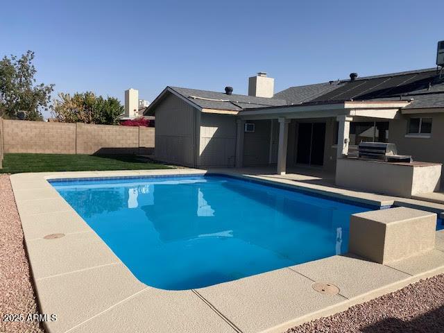 view of pool featuring a fenced in pool, a fenced backyard, a patio, and area for grilling