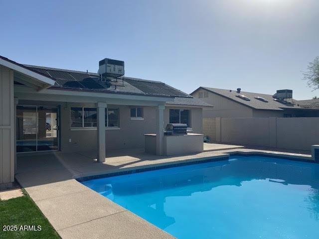 view of pool with a fenced in pool, a patio, area for grilling, a fenced backyard, and cooling unit