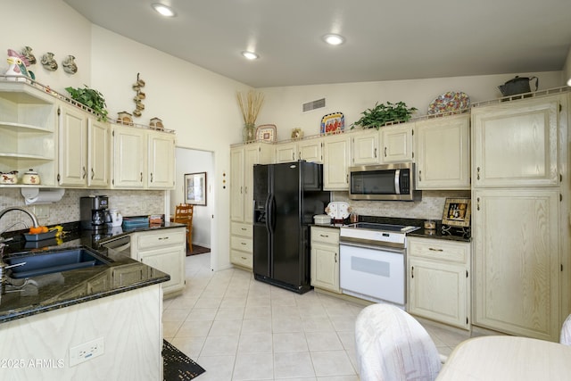 kitchen featuring sink, lofted ceiling, backsplash, and black appliances