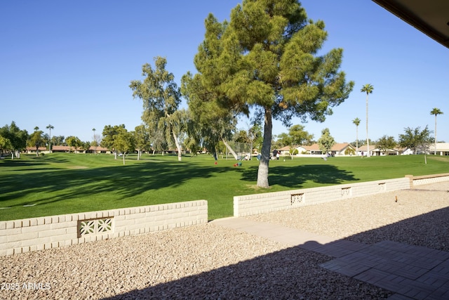 view of property's community with a lawn