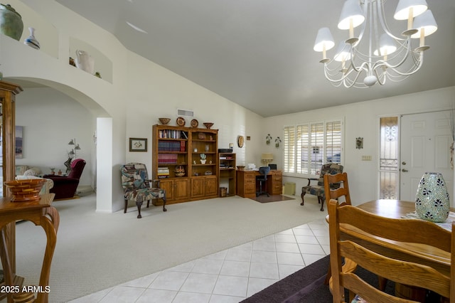 dining room with vaulted ceiling, a chandelier, and light colored carpet