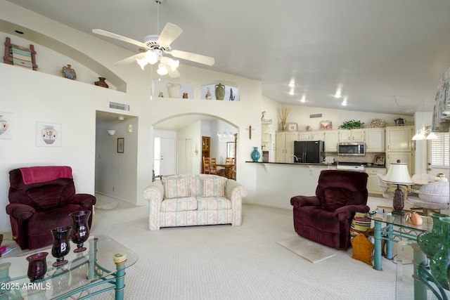 living room with light carpet, vaulted ceiling, and ceiling fan