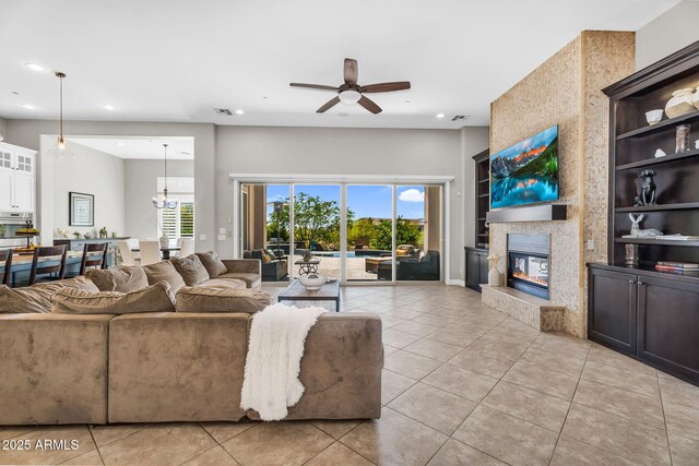 37308 N 100th Pl, Scottsdale, AZ 85262 - living area featuring visible vents, light tile patterned flooring, recessed lighting, a fireplace, and ceiling fan with notable chandelier