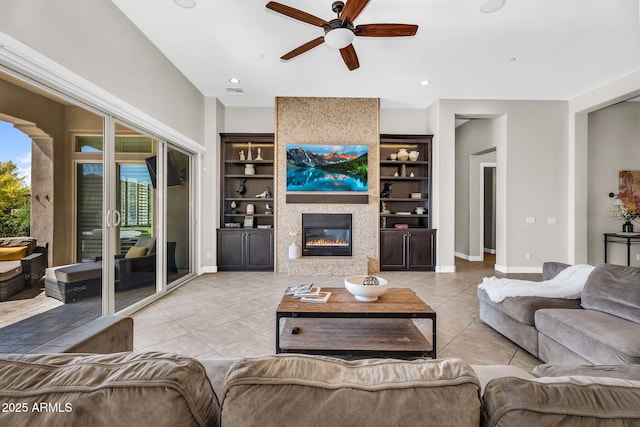 37308 N 100th Pl, Scottsdale, AZ 85262 - living room with light tile patterned floors, a large fireplace, baseboards, a ceiling fan, and built in shelves