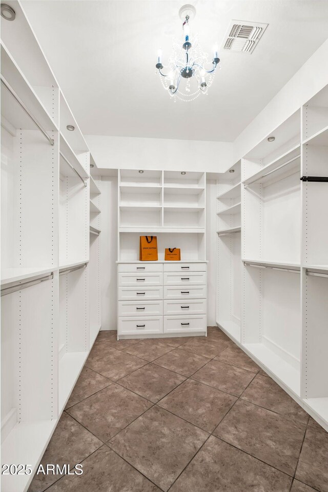 37308 N 100th Pl, Scottsdale, AZ 85262 - spacious closet featuring an inviting chandelier, visible vents, and dark tile patterned flooring