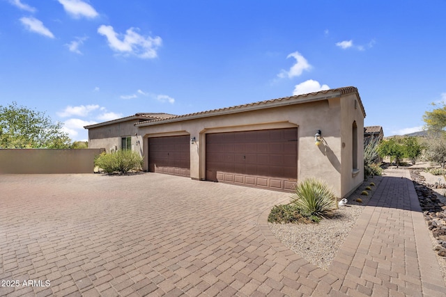 37308 N 100th Pl, Scottsdale, AZ 85262 - view of side of property with decorative driveway, a garage, and stucco siding