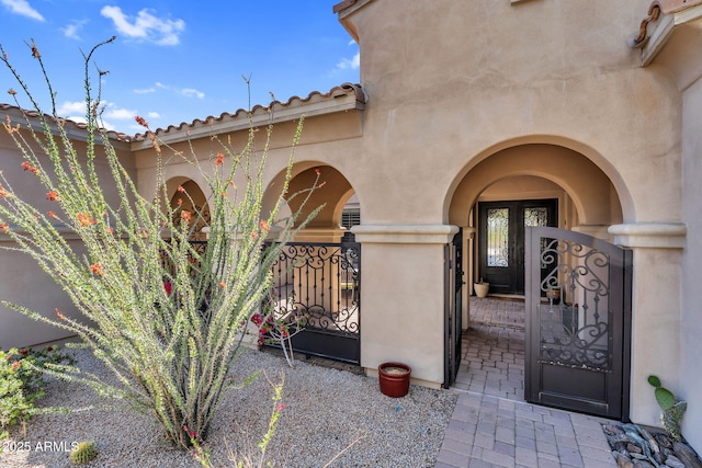 37308 N 100th Pl, Scottsdale, AZ 85262 - view of exterior entry with stucco siding, a gate, and french doors