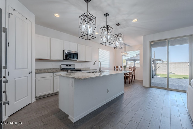 6117 S Adelle, Mesa, AZ 85212 - kitchen featuring dark wood-style flooring, a chandelier, light stone counters, a sink, and stainless steel appliances