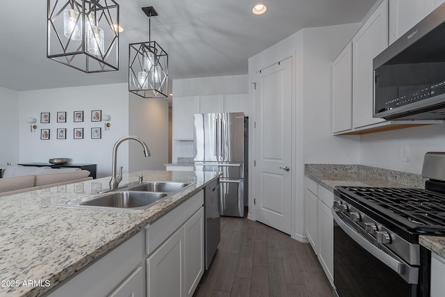 6117 S Adelle, Mesa, AZ 85212 - kitchen with appliances with stainless steel finishes, a sink, white cabinetry, dark wood-type flooring, and pendant lighting