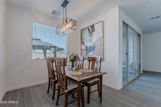 6117 S Adelle, Mesa, AZ 85212 - dining space with baseboards, visible vents, an inviting chandelier, and wood finished floors