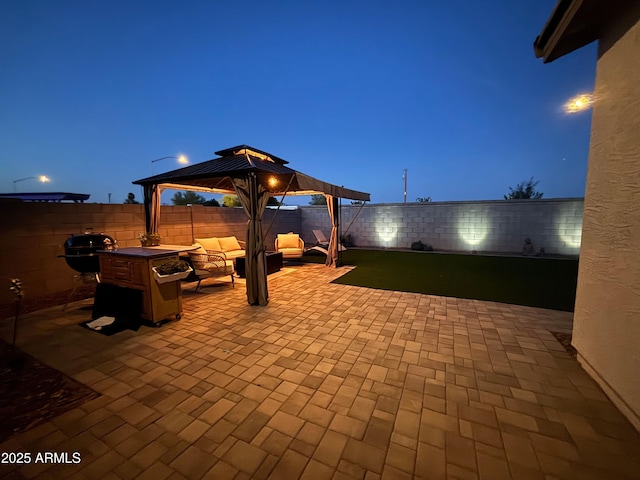 6117 S Adelle, Mesa, AZ 85212 - patio at twilight featuring a gazebo, a fenced backyard, and an outdoor living space with a fire pit