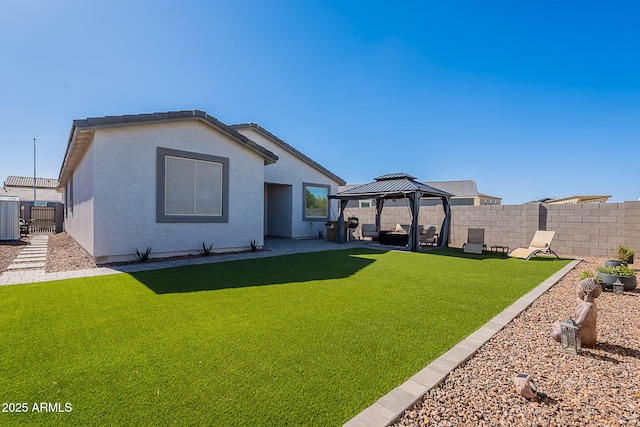 6117 S Adelle, Mesa, AZ 85212 - back of property featuring a fenced backyard, stucco siding, a patio area, a gazebo, and a yard