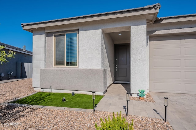 6117 S Adelle, Mesa, AZ 85212 - doorway to property featuring an attached garage and stucco siding