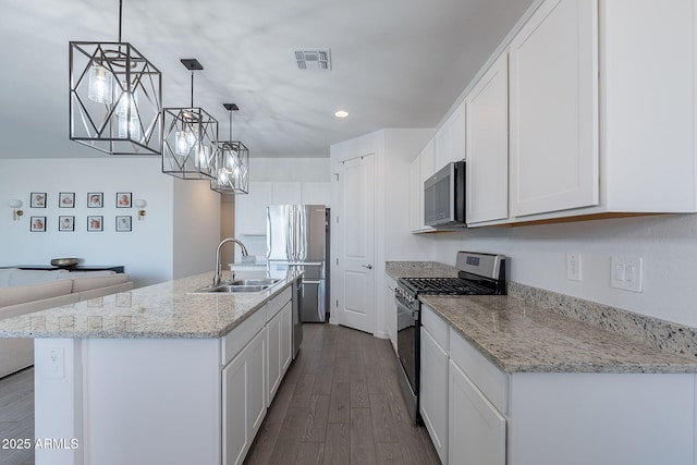 6117 S Adelle, Mesa, AZ 85212 - kitchen with appliances with stainless steel finishes, a center island with sink, a sink, white cabinets, and dark wood-style floors
