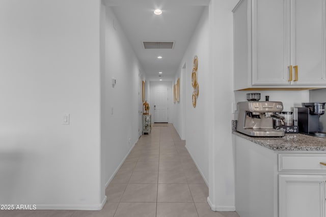 hall featuring light tile patterned floors